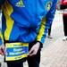 Runner Tim Schuster pins a bib to his shorts while wearing a 2013 Boston Marathon jacket on Saturday, April 20. Schuster participated in the marathon last week. AnnArbor.com I Daniel Brenner